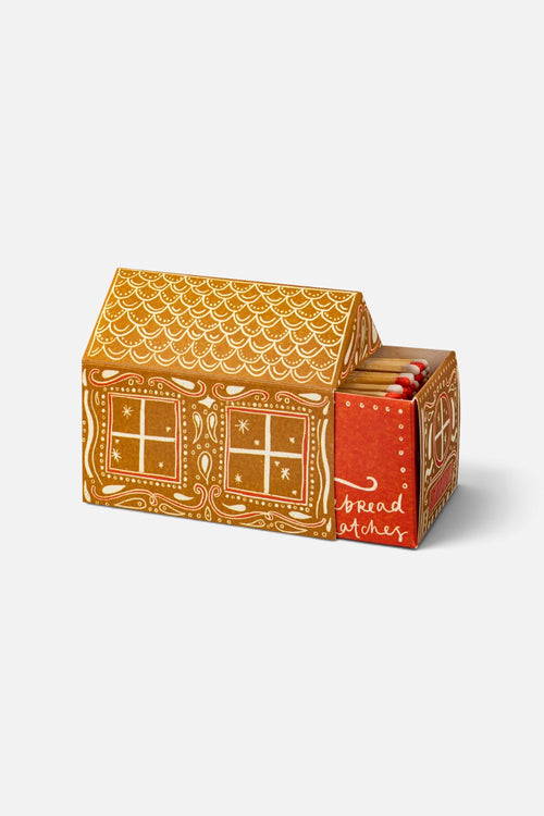 Archivist house-shaped matchbox illustrated as a gingerbread house with a bright red door.