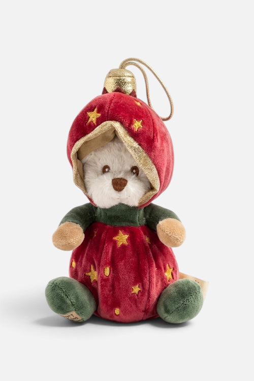 Bukowski Bears Ziggy plush ornament, a cream teddy bear in a red velvet bauble suit with gold stars, gold-trimmed hood and green velvet feet, hanging from a tree branch.