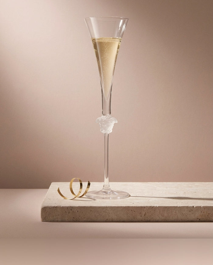 Statement holiday gift: Versace Medusa Lumière crystal champagne flute on a travertine block