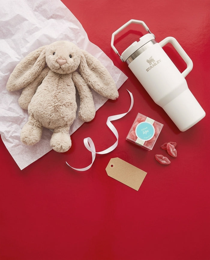 Holiday gifts under $50: Jellycat Bashful Bunny, Stanley IceFlow tumbler and Sugarfina Sugar Lips on red paper