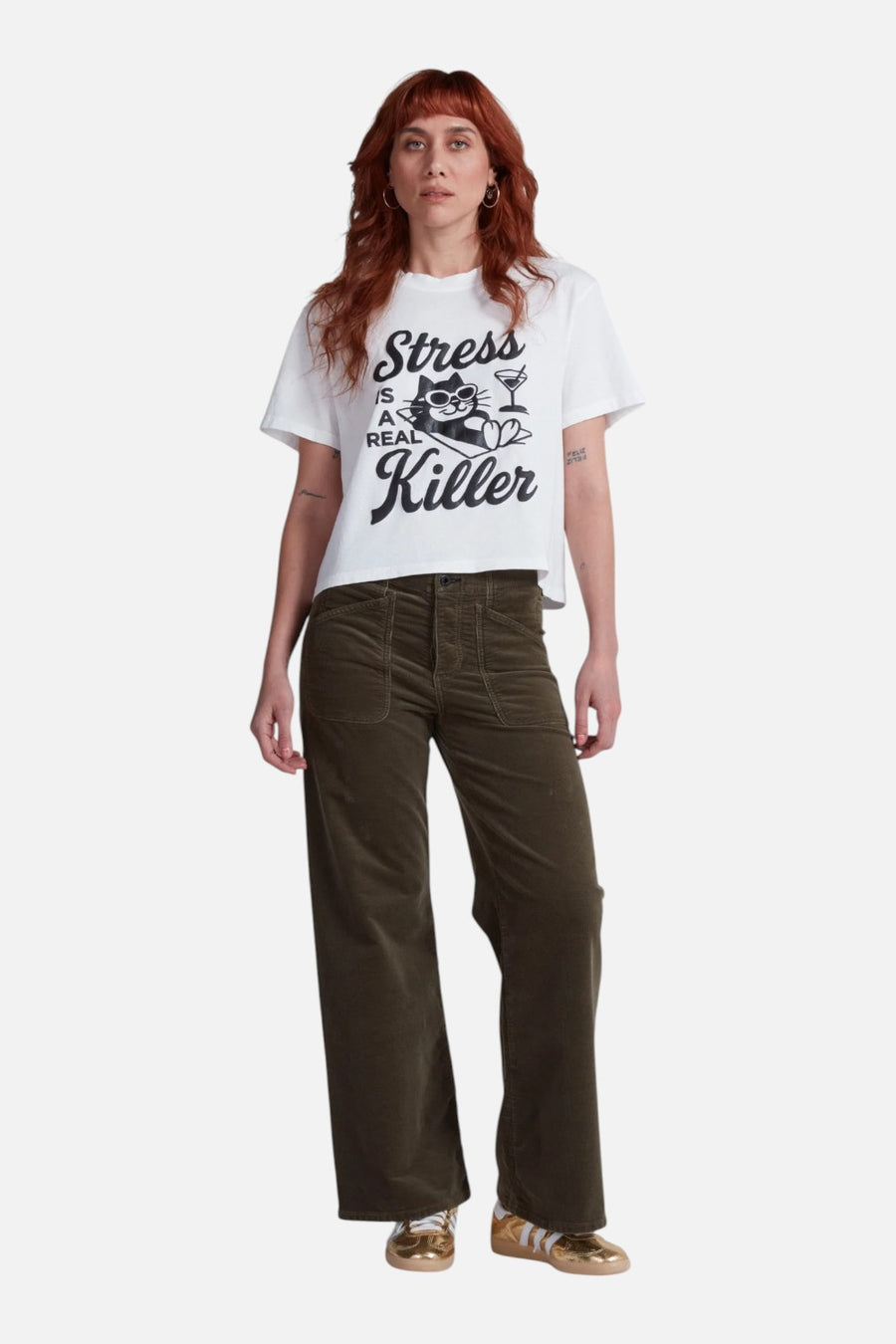 ASKKNY Stress is a Killer shrunken boy tee in white, worn with denim.