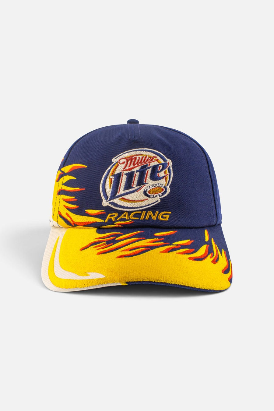 American Needle Roscoe racing snapback cap in navy and yellow Flame colorway, side view.