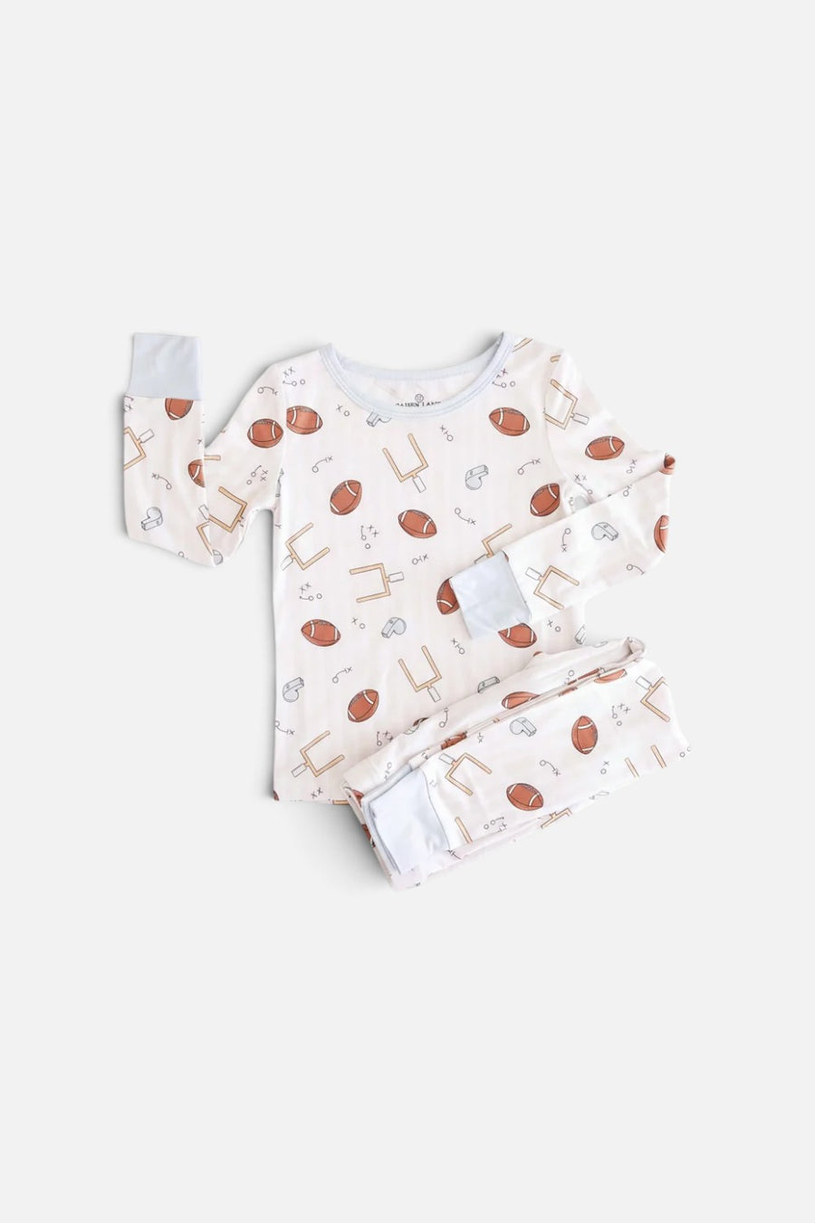 Caden Lane Tiny Touchdowns two-piece pajama set, long-sleeve top and pants in a striped football print.