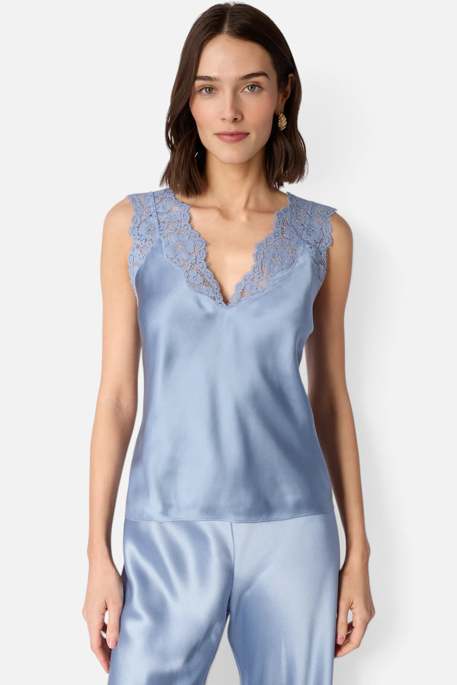 Cami NYC Ola bias-cut silk camisole in mist blue with a V-neckline and lace trim, on model.