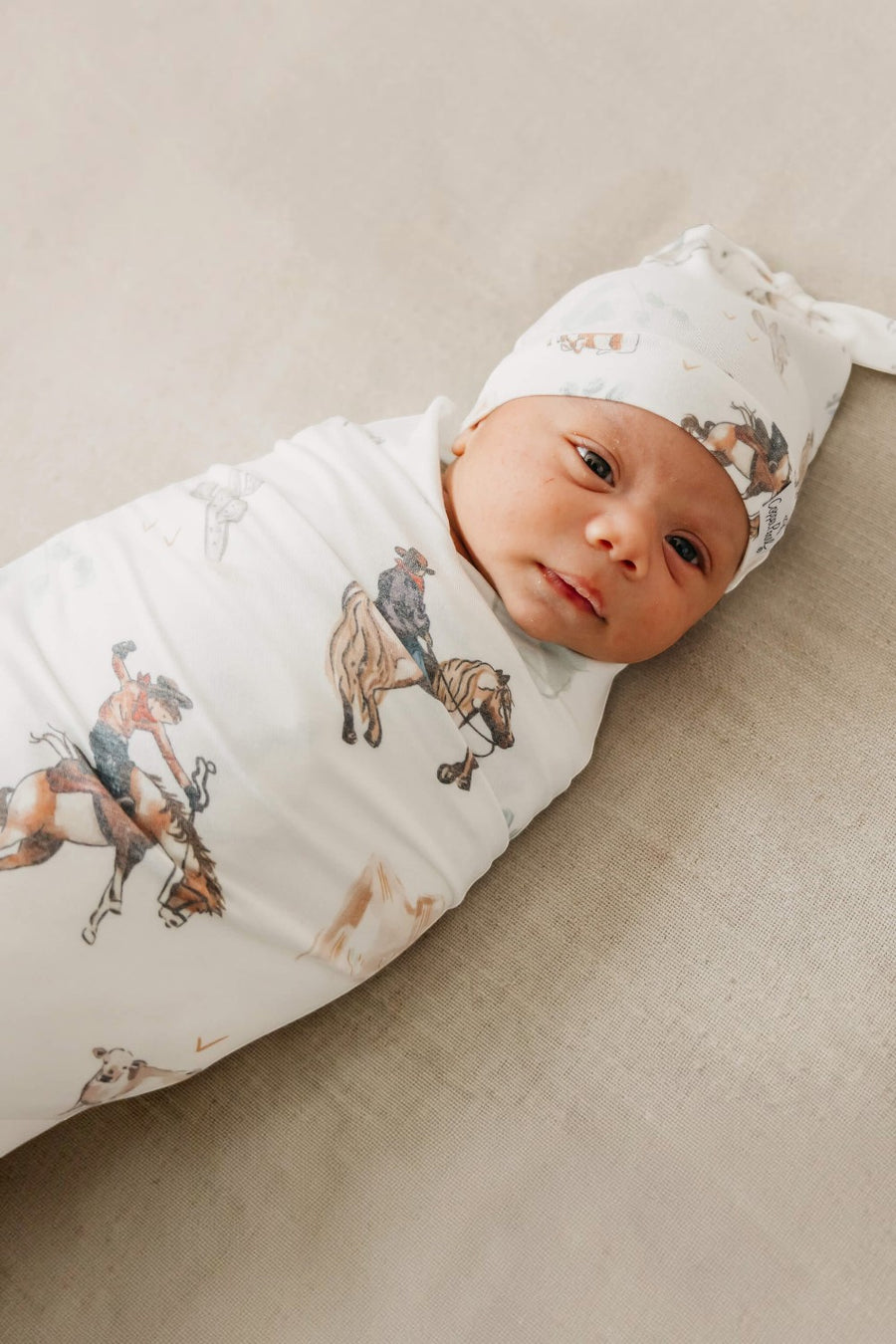 Copper Pearl Boone swaddle blanket styled in a nursery.
