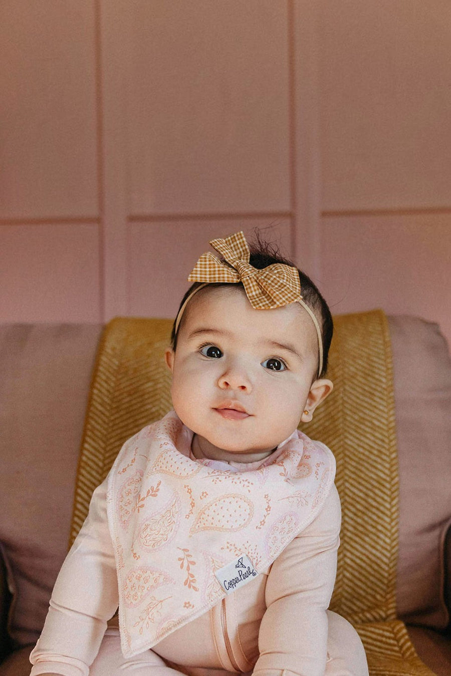 Copper Pearl Cheyenne baby bandana bib worn by a baby.