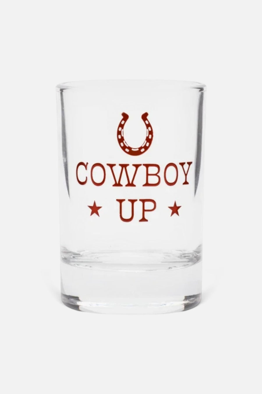 Fishs Eddy Cowboy Up clear shot glass with horseshoe design and red lettering.
