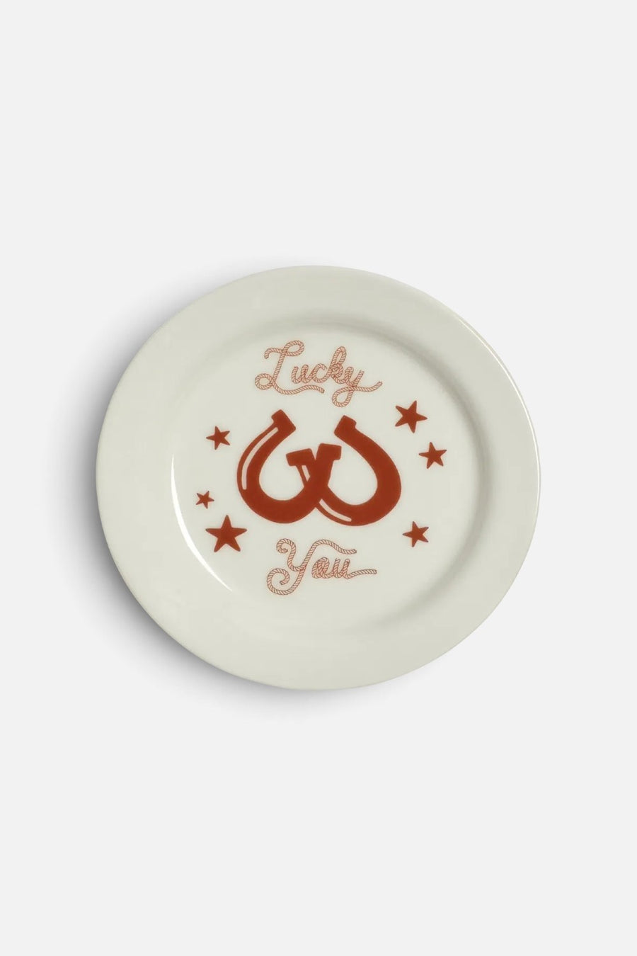 Fishs Eddy Lucky You small white stoneware plate with red horseshoe and star design.