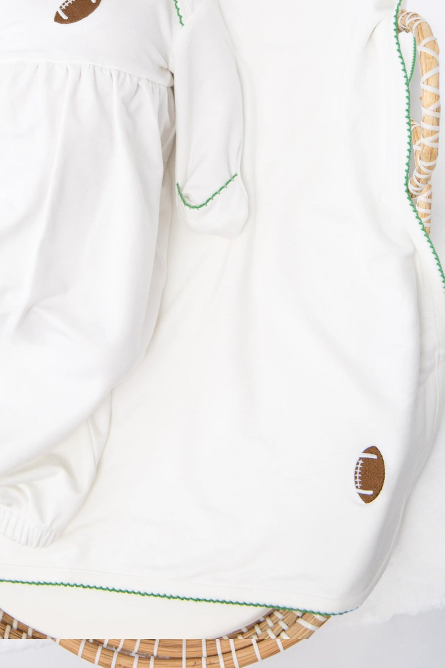 Goosies white double-layer bamboo baby blanket with varsity football embroidery and picot trim.
