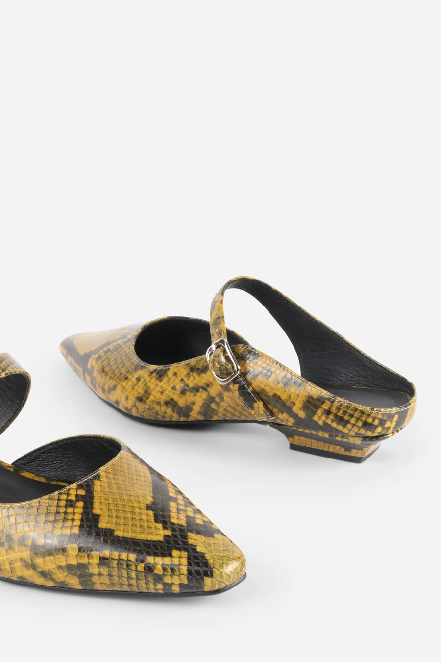 Intentionally Blank Nona snake embossed leather mule in yellow, detail of embossed leather.