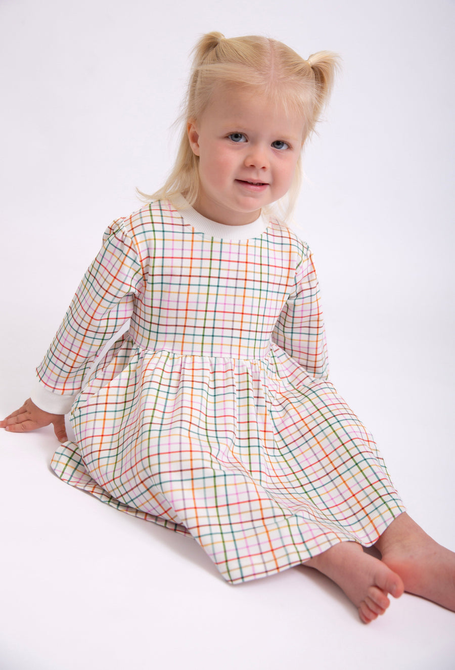 Goosies Sweatshirt Dress in AJ Plaid on a toddler, seated