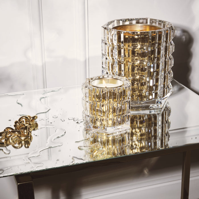 Baccarat crystal candles glowing on a mirrored table