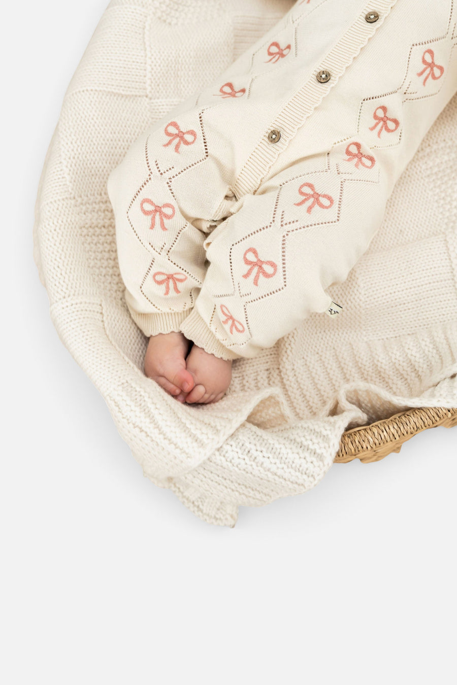 Evie Bow Pointelle Knit Baby Jumpsuit in Ecru – detail