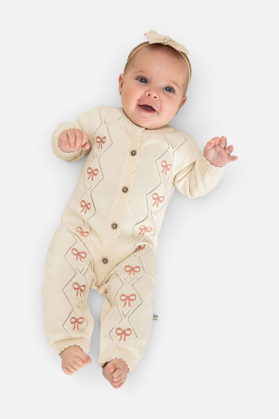 Evie Bow Pointelle Knit Baby Jumpsuit in Ecru – on model