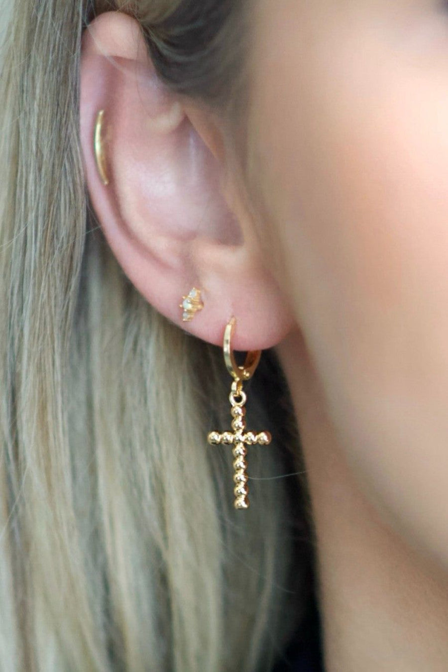 Farrah B Crossroads Cross Huggies Earrings in Gold – back view