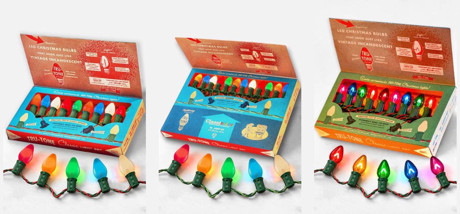 Tru-Tone C7 Classic Light Sets lit in front of their gift boxes: Classicolor 10-Light, Classicolor 25-Light and Jeweltone 10-Light