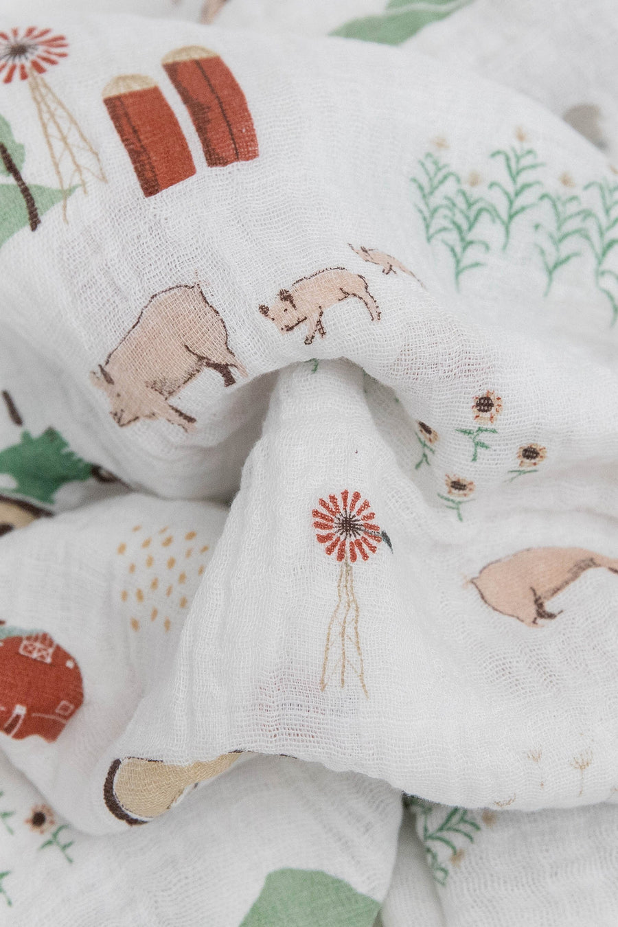 Little Unicorn Cotton Muslin Swaddle Blanket in Farmyard – side view