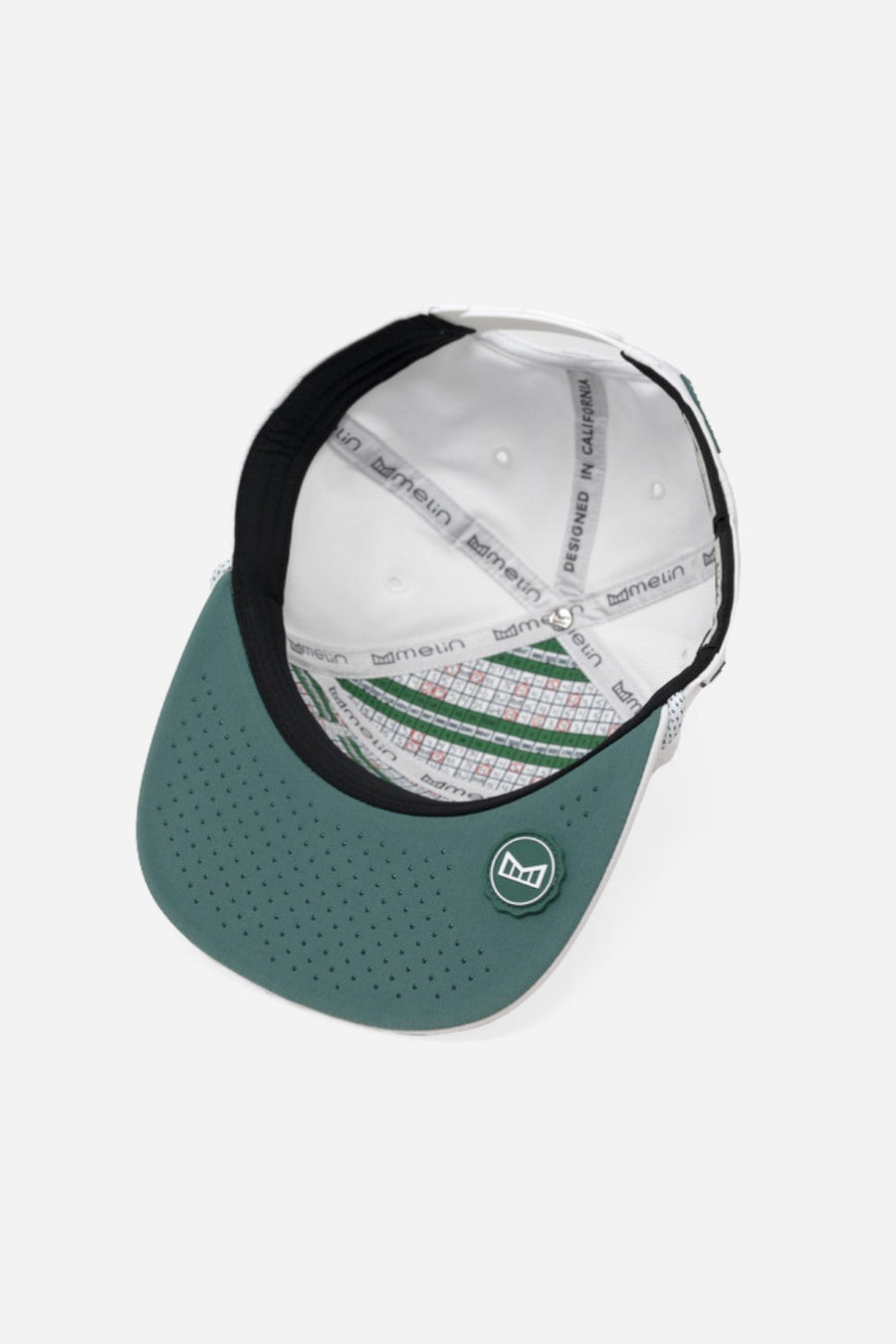 Melin Trenches Links Hydro Hat in White Green "How We Roll" – flat lay
