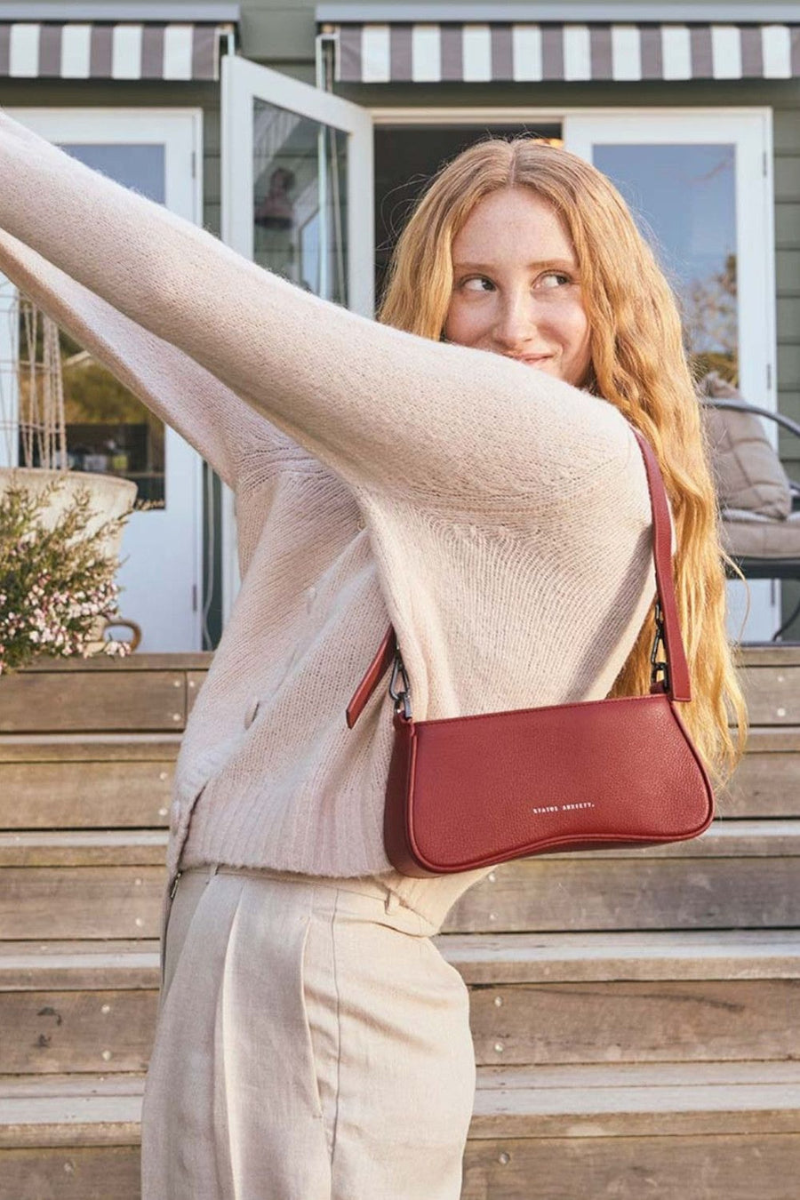 Status Anxiety Polaris Bag in Rouge – flat lay